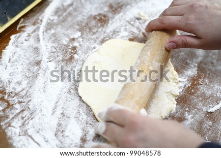 Rolling out cookie dough on a cutting board
