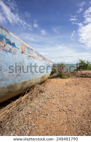 wreck boat on land with blue sky in Thailand