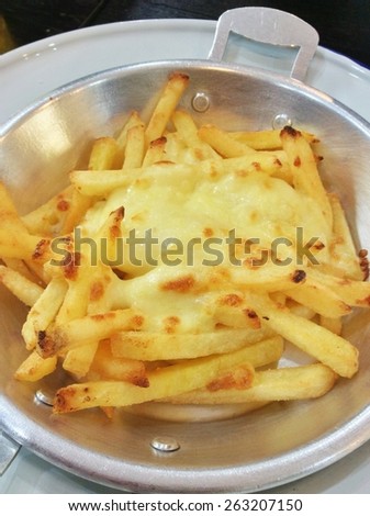 french fries with cheese in hot pan