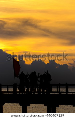 People dance in celebration beach party  in summer vacation concept, sunset time