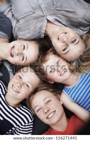 Happy family portrait of mother and four siblings