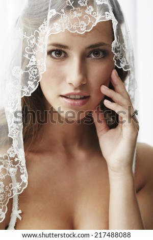 Young bride in wedding veil, studio shot