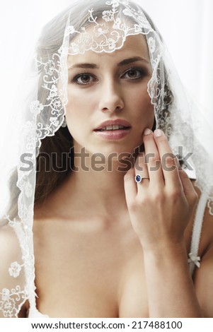 Young bride in wedding veil, studio shot