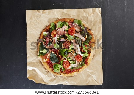 Fresh Italian pizza with ham and salad