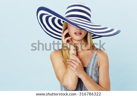 Sensuous woman in swimsuit and fashionable hat
