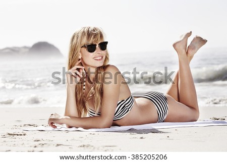 Sun and shades for bikini girl at beach
