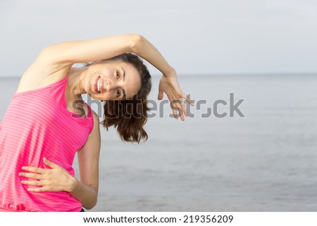 Woman stretching her side body outdoors