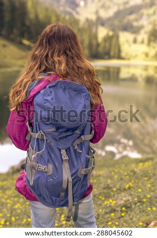 Woman watching the lake view during a hiking trip
