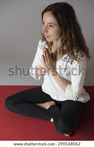 Woman meditating in prayers pose