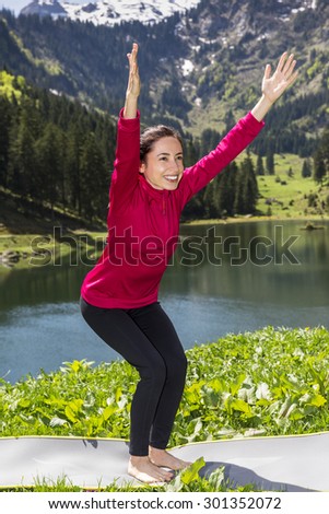 Woman doing chair pose outdoors