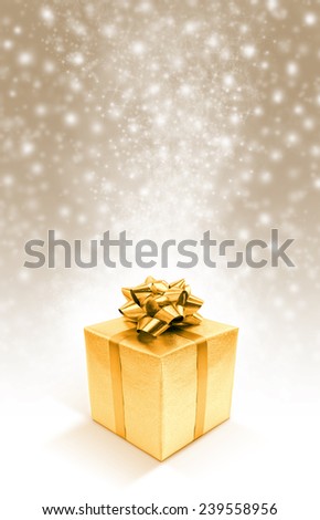 Golden celebration gift box on sparkle background