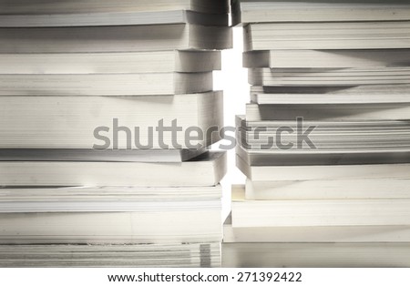 many old book stack and a little space like the way out