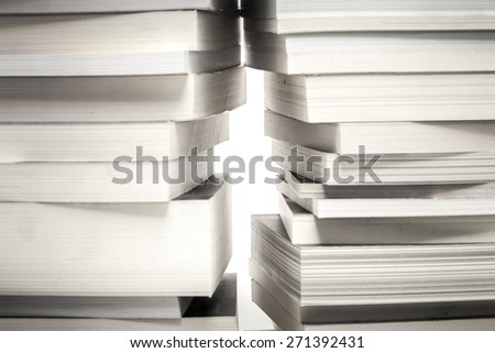 many old book stack and a little space like the way out