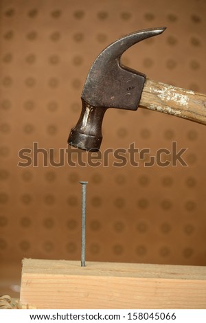 Old hammer and nail in carpenter\'s wood shop