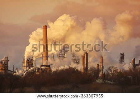 Air pollution from smoke stacks at oil refinery