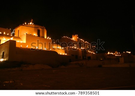 Night shot of easter religious tradition with lit tin cans with fire in village of Pyrgos the night before Jesus resurrection, Santorini island, Cyclades, Greece
