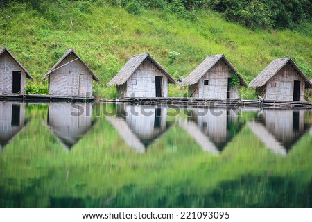 Raft house on the lake with perfect reflection