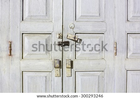 Folding wooden door frame with stained color in countryside.