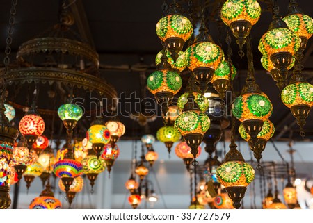 Colorful Moroccan style lanterns hanging down from ceiling.