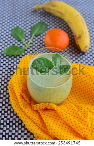 Vegan smoothie with spinach, banana, orange, agave syrup and soy yogurt