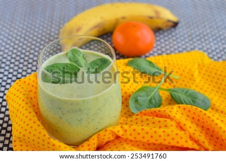 Vegan smoothie with spinach, banana, orange, agave syrup and soy yogurt