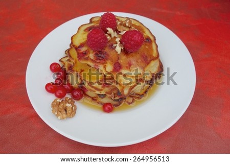 Raspberry and red currant pancakes with walnuts and maple syrup