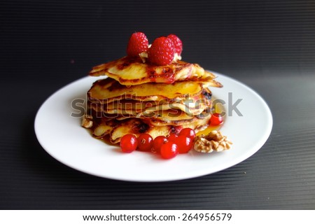 Raspberry and red currant pancakes with walnuts and maple syrup