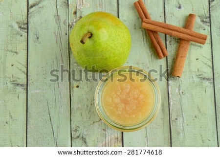 Pear Sauce in a Jar Glass with Pear Fruit and Cinnamon Sticks