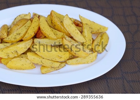 Potato Wedges with Dill on Serving Plate