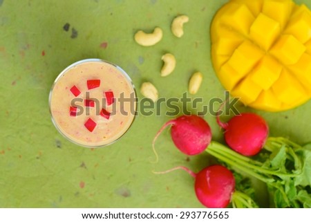 Mango smoothie with red radishes and cashew nuts