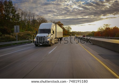 Old semi truck on road with sun flare