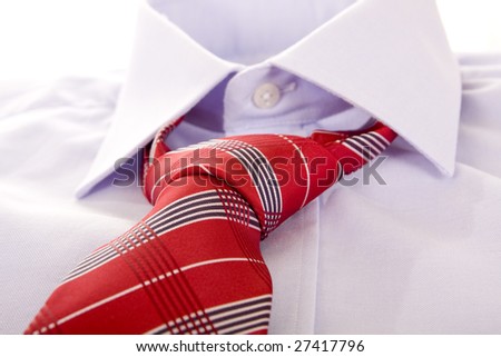 Blue shirt and red tie on white