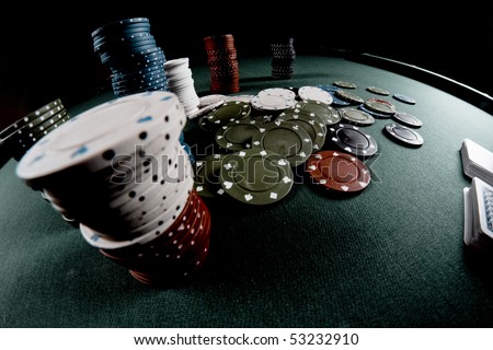 Casino gambling chips on green table
