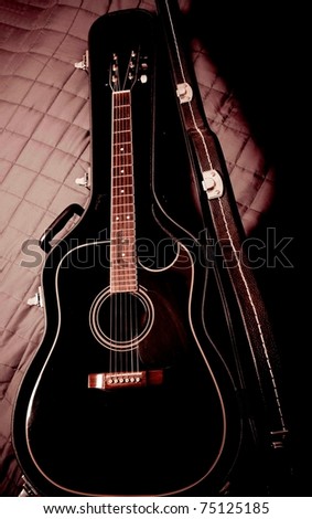 black shiny acoustic guitar  in case