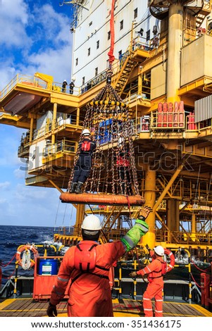 Boom lift people offshore oil into the cargo tanker.