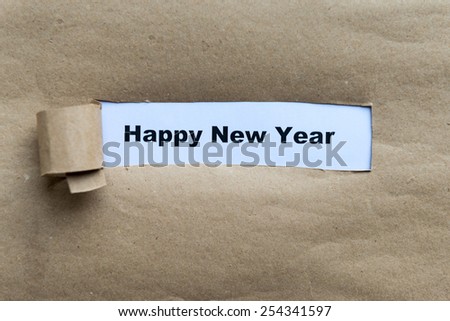 happy new year word on the torn paper background