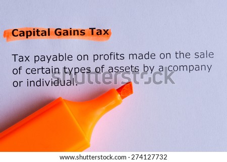 capital gains tax word highlighted on the white pa