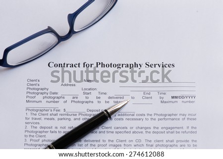 contract for photography service  on the white paper with pen