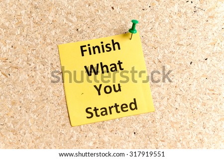 finish what you started word typed on a paper and pinned to a cork notice board