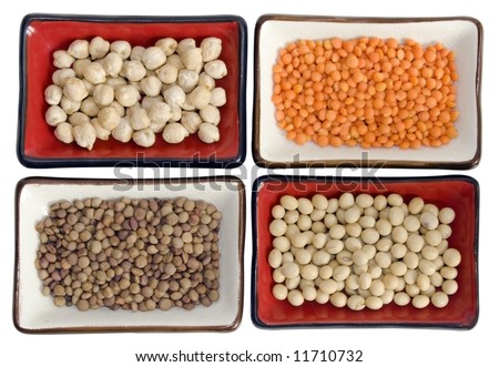 stock photo : Close up of four dishes with (from up right clockwise): chickpeas, red lentils, soybeans, small lentils. Soft focus. It has a clipping path.