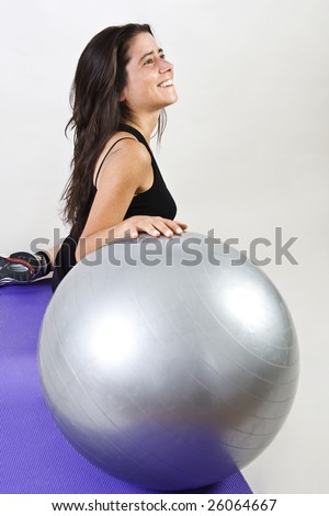 Sportive, smiling, happy woman with gym ball at the gym. Copy space.