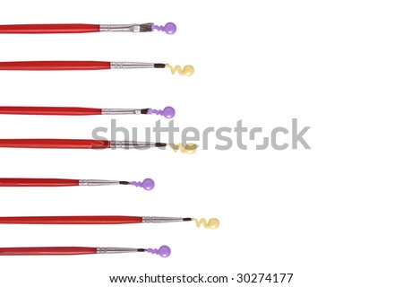 Seven paintbrushes with paint on their tips on white background. It has a clipping path. Copy space.