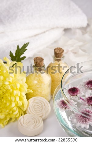 Image of relax & beauty, composed by white towels, bath salts, soap, and flowers.