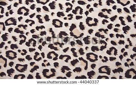 Animal print, leopard pattern fabric background in brown colors.