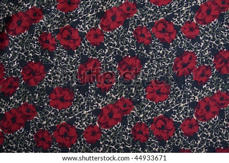 Animal print and flowers fabric background. Full frame.