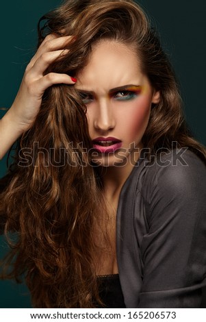 Beautiful portrait. Bright makeup. Girl with hand in hair.