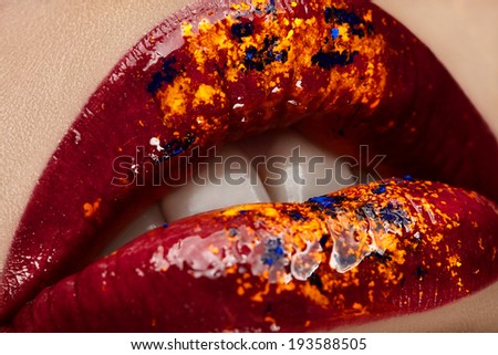 Beautiful female with red shiny lips close up.
