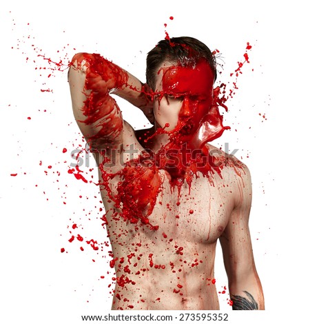 Bright splashes of red paint on a young guy. White background.