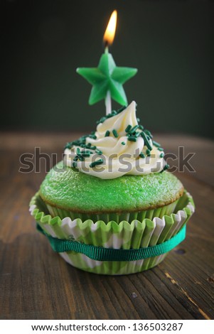 Green birthday cupcake with star candle on top