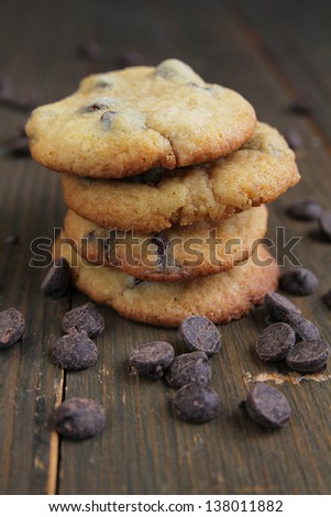 Chocolate chips cookies on a wooden chips cookies surrounded by chocolate chips cookies